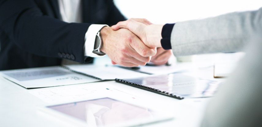 close-up of business man and woman shaking hands